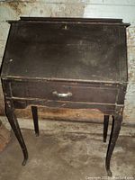 Front view of vintage wooden secretaire desk showing worn dark finish and Queen Anne legs