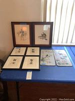 Overview of all Japanese art pieces including framed figurative prints, framed calligraphy, and silk panels.