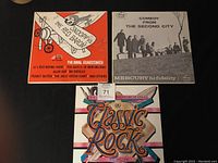 Three assorted record albums placed side by side, showing front covers of The Royal Guardsmen's Snoopy's The Red Baron, Comedy from The Second City, and London Symphony Orchestra Classic Rock Volume One.