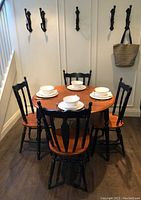 Front view of dining table with all four chairs and place settings (plates and bowls not included)