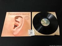 Vinyl record LP outside sleeve with label and accompanying album sleeve showing ear and mouth artwork and title.