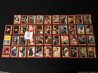 Photo showing 43 Star Wars Return of the Jedi collector cards laid out in rows, featuring various characters and scenes from the 1983 movie series.