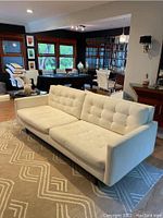 Overall view of cream mid-century modern sofa in living area