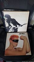 Photo showing Bruce Springsteen Born to Run album on top of stack with The Eurythmics album below