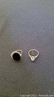 Overview of both rings on black cloth background