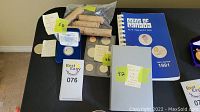 Overview of Canadian coin assortment, showing rolls, coin sets, and book.