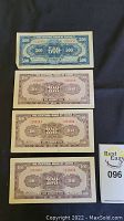 Four Chinese yuan bills laid out flat, including one 500 yuan and three 100 yuan banknotes from The Central Bank of China.