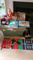 Full view of lot showing standing Santa, books, candles, banners, and collected ornaments in boxes
