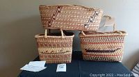 Three rectangular woven baskets grouped on table