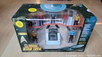 Front view of unopened Classic Star Trek Playmates action figures set showing all figures and chair inside display packaging.