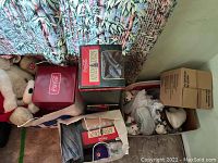 Photo of multiple Coca Cola items including stuffed bears and boxed collectibles.