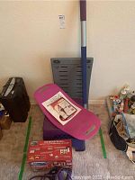 The Firm body sculpting system components including two purple exercise steps, a blue and silver bar with purple grips, and a workout DVD placed on the top exercise step.