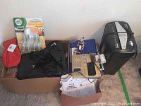 Image showing Aurora AU870MA shredder, Dell Inspiron laptop, Air Wick essential oils with warmer in packaging, vintage adding machine, file folders, and boxes.