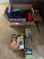Photo of box with various office supplies, organizational folders, and pet supplies.