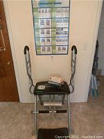 Full view of Malibu Pilates Pro unit against wall with instructional materials on seat.