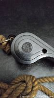 Top side of antique metal whistle showing 'BEST MAID' embossed logo.