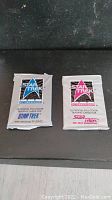 Two unopened Star Trek trading card booster packs from 1991, one in blue design Original Series pack and one in pink design Next Generation pack