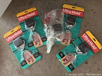 Four Ultra-Hold brand storage organizers in original packaging and a 9.6 volt saw wrapped in plastic