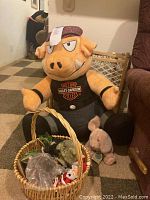 Large plush Harley-Davidson Hog sitting behind Easter basket filled with small plush bunny and assorted holiday decorations.