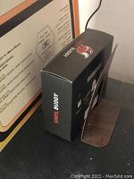 Photo showing Vinyl Buddy box next to vinyl record sleeves and partially visible framed school orchestra certificate.