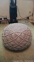 Side view showing intricate macrame woven design and texture on the pouf ottoman.