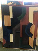 Framed oil painting featuring abstract geometric shapes in browns, blacks, and blues
