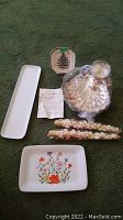 Photo of the lot including the Spode Christmas Tree plate, two Kahla and Tivoli serving platters, silver plated shrimp server with candle holders, and two taper candles.