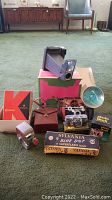 Full lot overview showing Keystone K30 camera, original box, leather case, flash unit, photo block, and flash bulb boxes.
