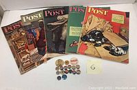 Five vintage Saturday Evening Post magazines from the 1940s laid in a row with colorful illustrated covers depicting various scenes including animals and people.