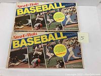 Two Start-O-Matic Baseball board game boxes placed side by side, showing front cover artwork with baseball action photos and branding.