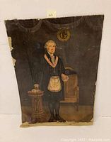 Full view of the lithograph showing George Washington in Masonic attire standing beside a chair and small podium on a linen backing with visible wear and damage.