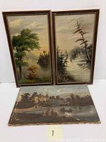 Two framed oil paintings standing side by side and one unframed painting on floor showing overall lot contents