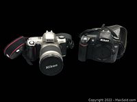 Two Nikon cameras displayed against black background. Left: Nikon F65 with lens and strap, Right: Nikon D80 with body cap and strap.