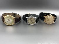 Three vintage wristwatches from Sparewa, Langel, and Orion in a row showing their faces and straps.