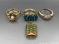 Top view of all four pieces showing detail and color of stones and metal.