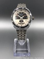 Front view of Ramona 17 jewel sports wristwatch on clear stand, showing panda dial and rotating bezel.