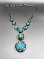 Full view of the sterling silver turquoise necklace showing the stones and chain.