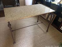 Front angle showing the full table with quartz top and metal frame base