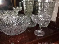 Photo of crystal vase, bowls, and candy dish showing cut glass designs and reflections