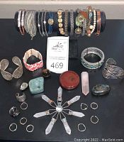 Full view of bracelets on stand and chakra stones laid out in front