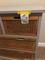 Close-up of middle and bottom basket weave drawers showing the weave design and wooden frames.