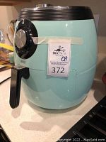 BlueNest Home light blue air fryer showing dial and black handle front view