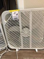 Photo showing a white Hurricane box fan with plastic grille and carrying handle on top.
