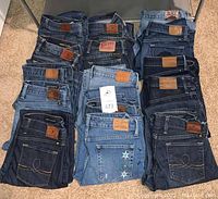 Overview of all folded jeans in four columns and four rows