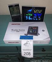 Front view of Equity device, Smartpro SC93 weather station, box of Smartpro SC93 and auction tag