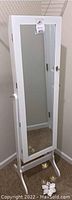 Full white wooden standing jewelry cabinet mirror with key lock visible, shows front view