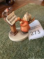 Front angle image of the figurine showing the child playing violin and birds on music stand.