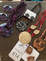 Photo showing four Karla Jordan Creations jewelry sets with necklaces and matching earrings in various colors and designs.