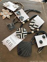 Photo showing all three necklaces and their matching set of earrings arranged on a surface.