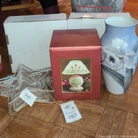 Photo of Lenox boxed tealight lamp, floral vase, and two silver plated star baskets on floor